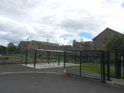 Oblique view of bike shelter and gates in front of King James Middle School, Bishop Auckland July 2016
